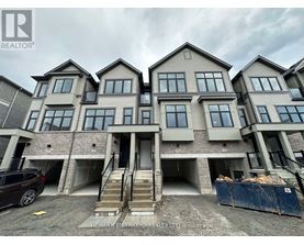 A row of new houses with a car parked in front of the first one.