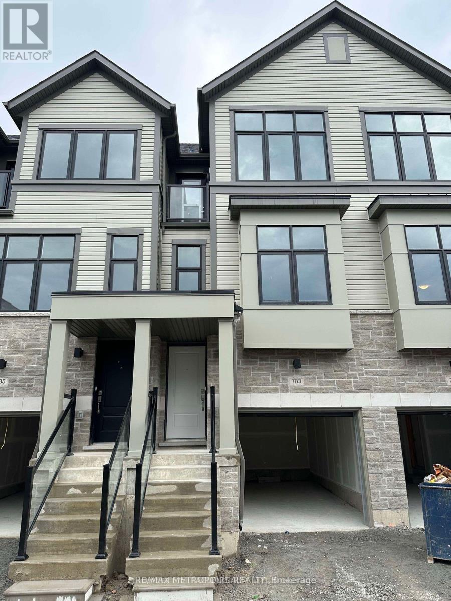 A two story house with a garage underneath.