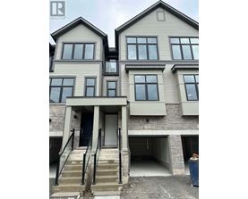 A two story house with a garage underneath.