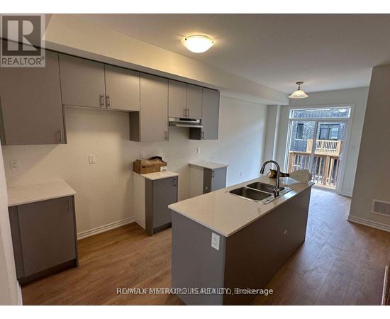 A kitchen with a sink and a window.