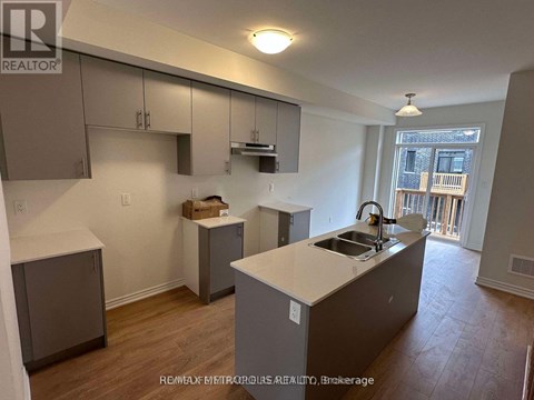 A kitchen with a sink and a window.