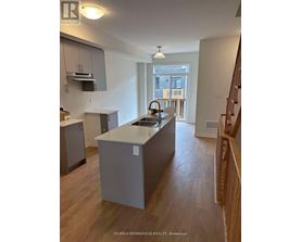 A kitchen with a sink and a window.