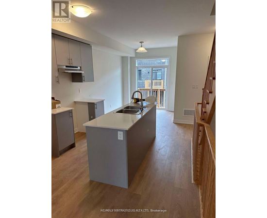 A kitchen with a sink and a window.