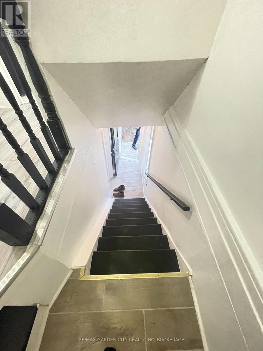A staircase with a black and white striped railing.