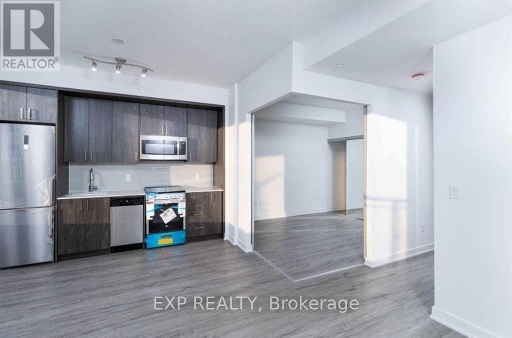 A realtor sign is in the corner of a kitchen.