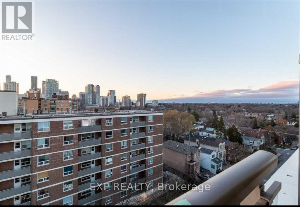 A brokerage sign is displayed on a balcony overlooking a cityscape.