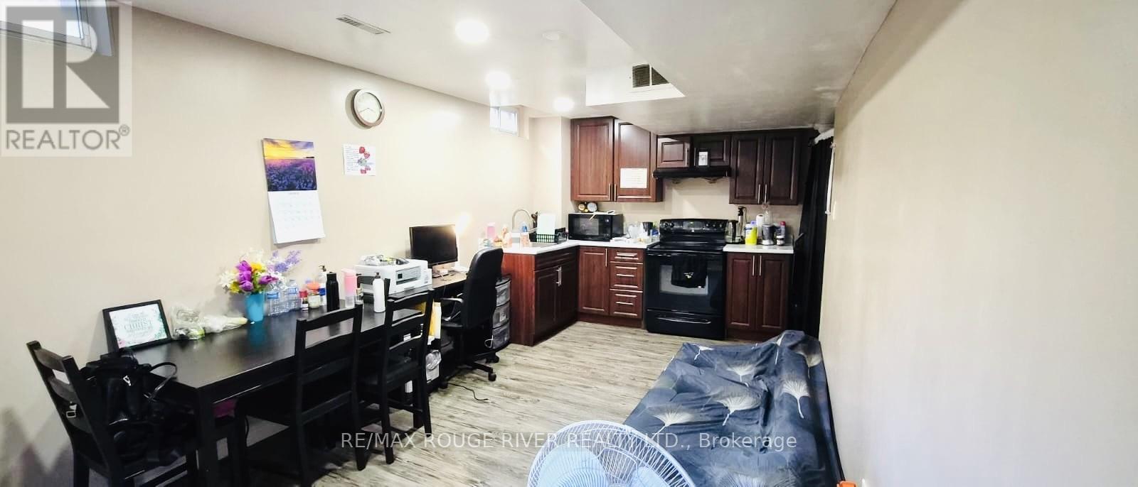 A realtor's office with a kitchen area in the back.
