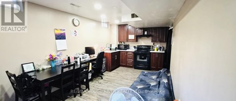 A realtor's office with a kitchen area in the back.