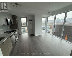 A spacious kitchen and living room with a view of the city.