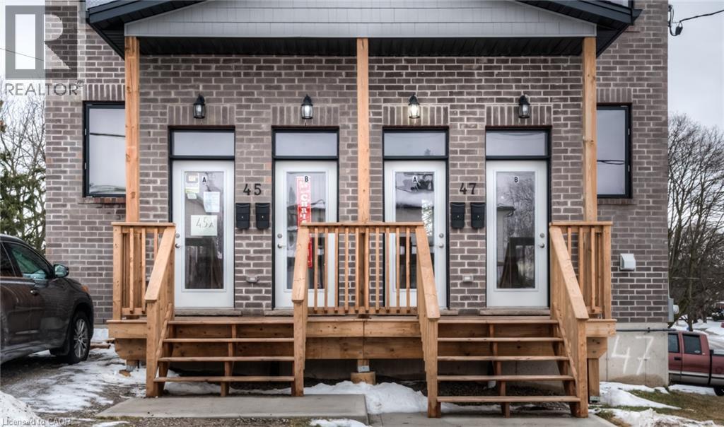 A house with a porch and a car parked in front.