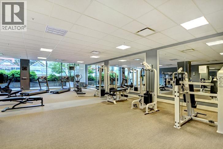 A gym with a variety of equipment including treadmills, weights, and exercise machines.