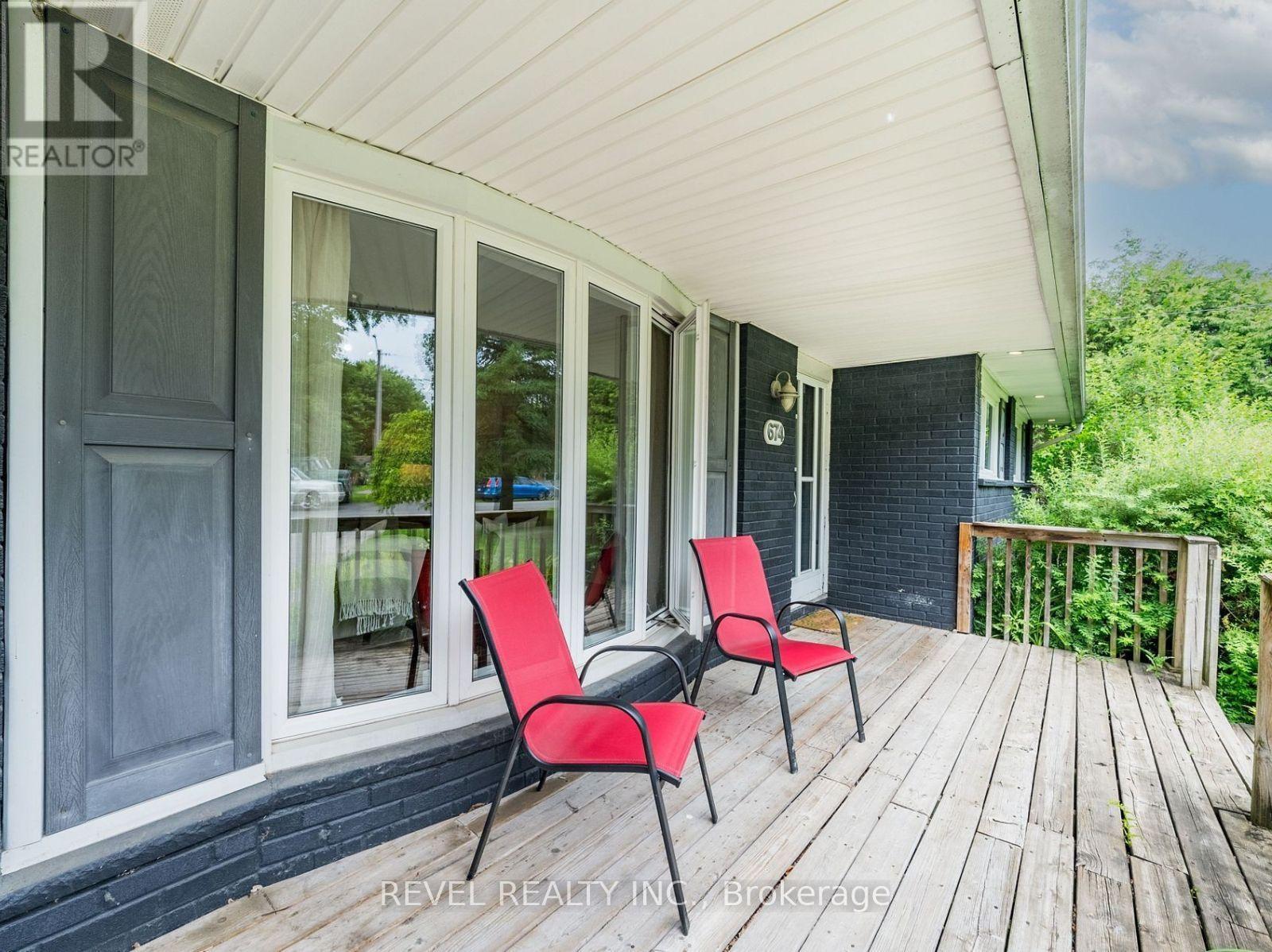 A balcony with two chairs and a table.