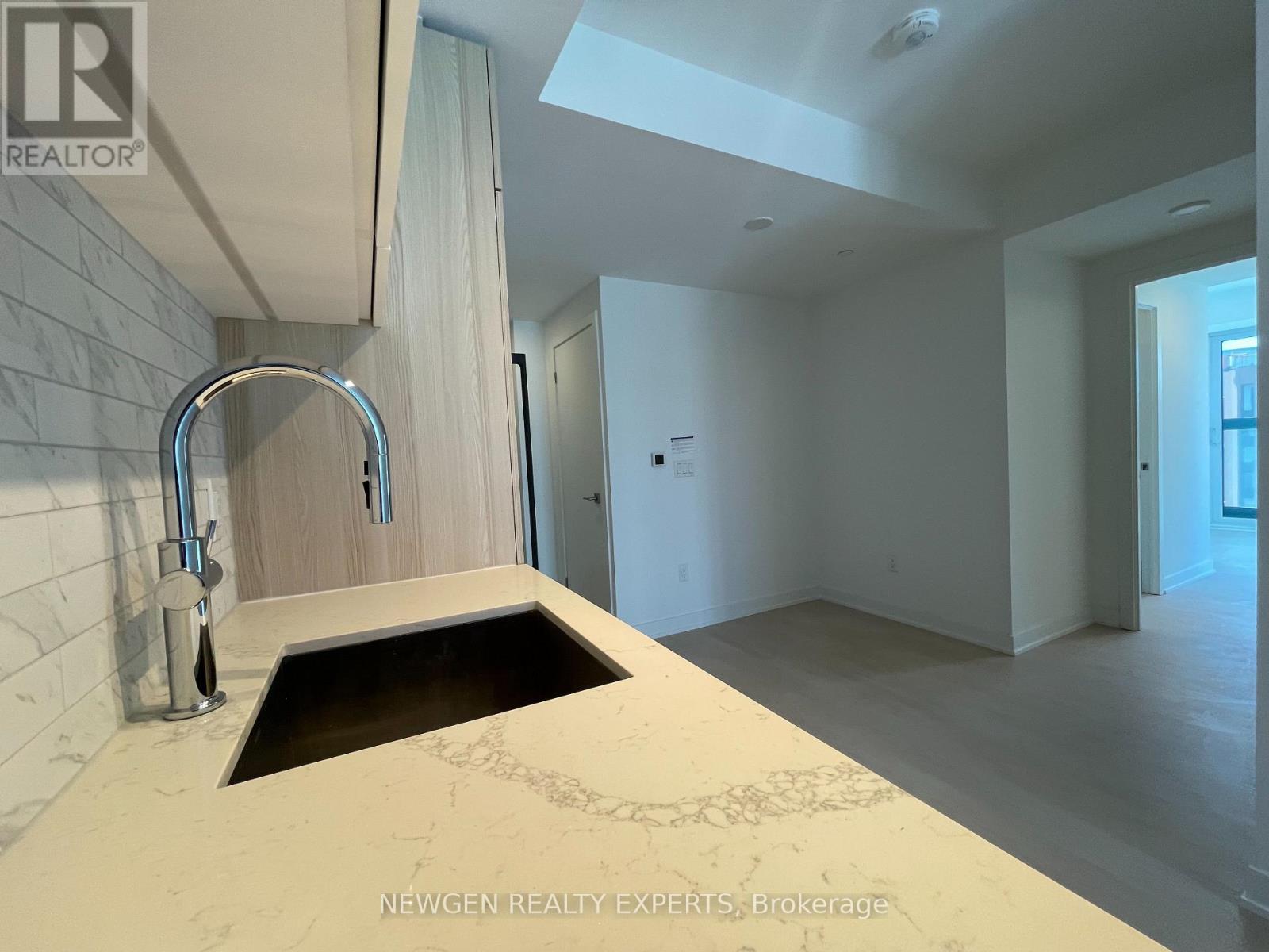 A modern kitchen with a sink and a skylight.