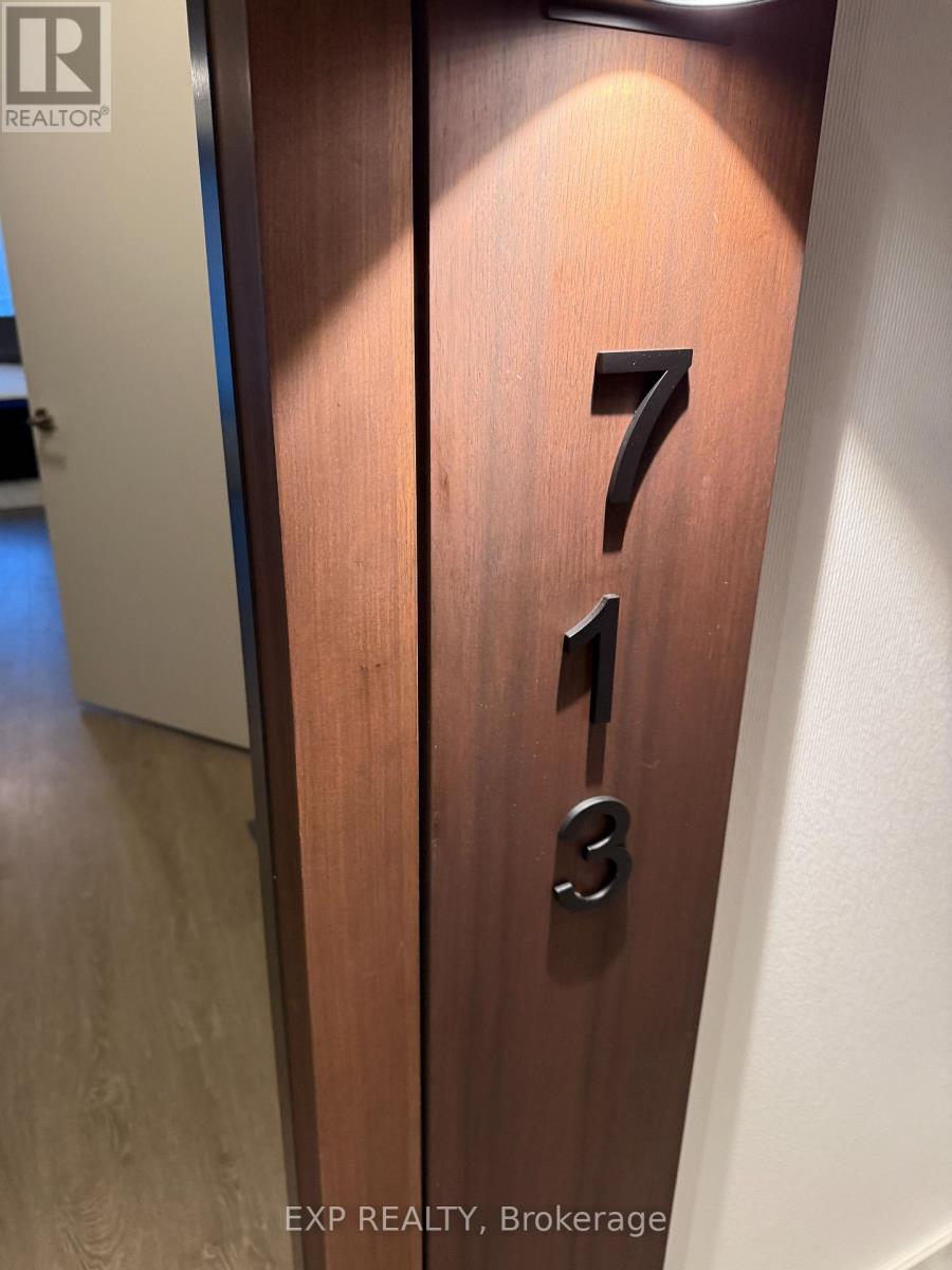 A brown door with the number 713 on it.