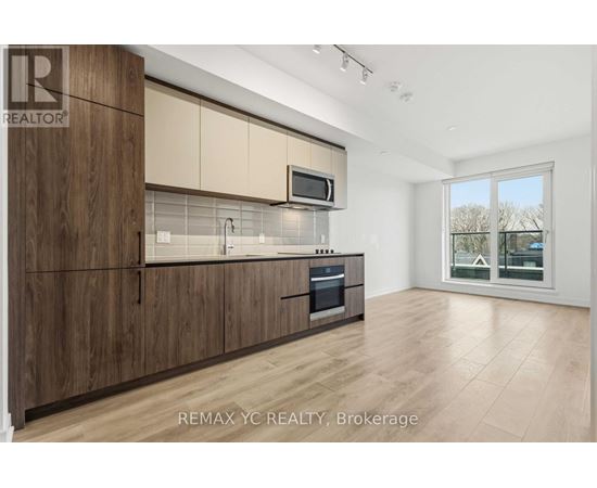 A kitchen with wooden cabinets and a microwave above the oven.