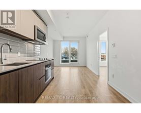 A modern kitchen with wooden cabinets and a stainless steel oven.