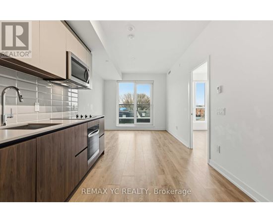 A modern kitchen with wooden cabinets and a stainless steel oven.