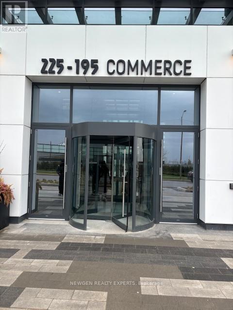 The entrance to a building with the number 225-195 Commerce displayed above it.
