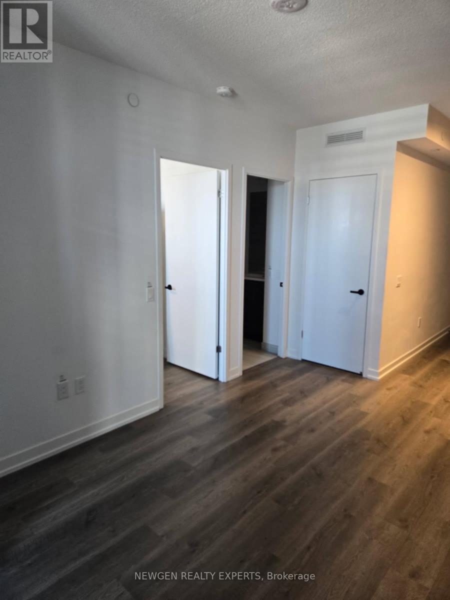 A room with a sliding glass door leading to a balcony.
