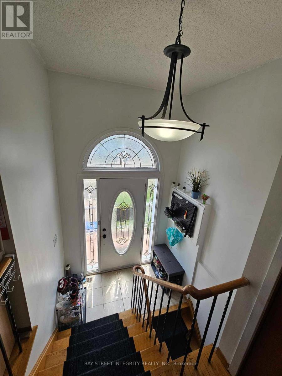A view of a staircase with a black mat on the floor.