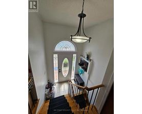 A view of a staircase with a black mat on the floor.