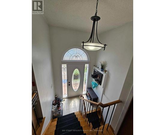A view of a staircase with a black mat on the floor.