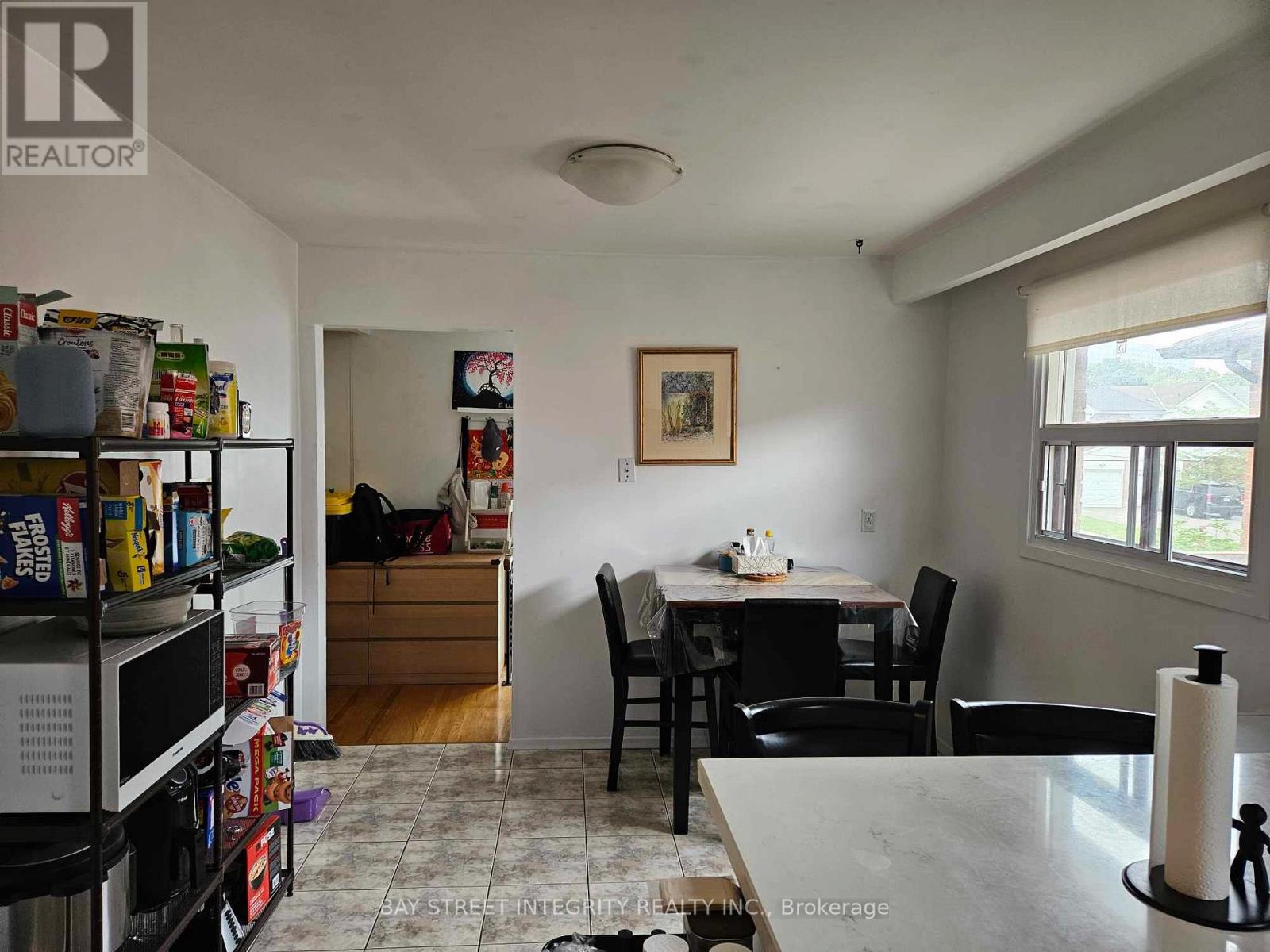A kitchen with a dining table and chairs.