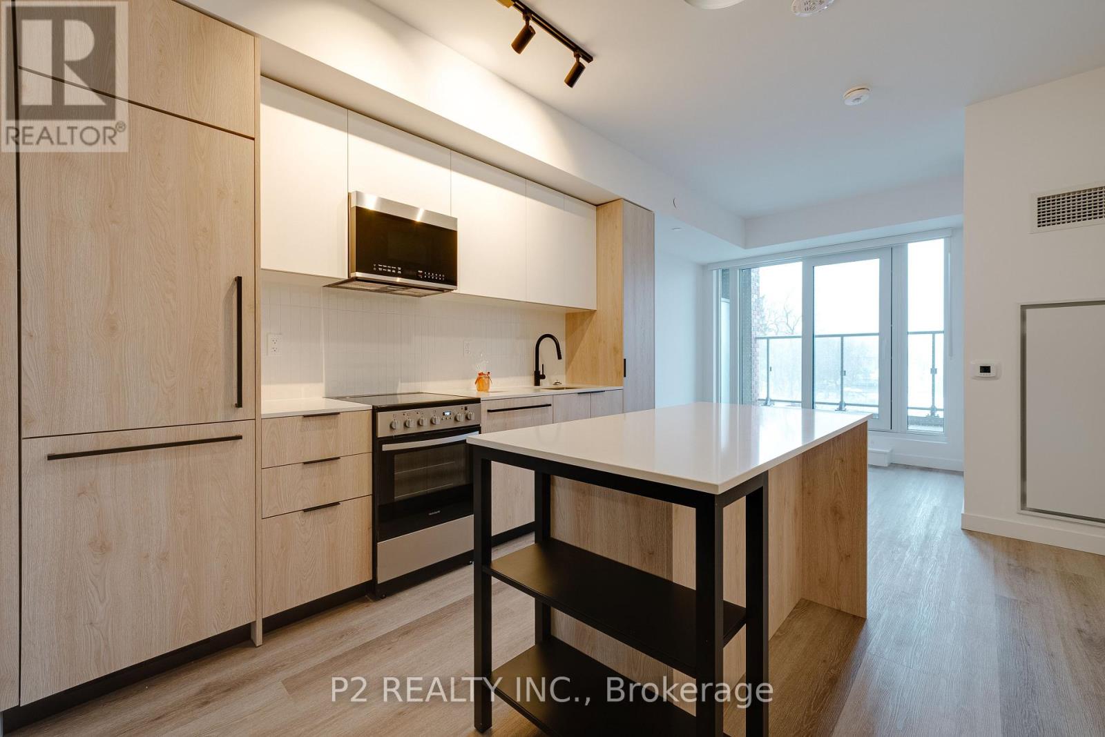 A modern kitchen with wooden cabinets and a central island.