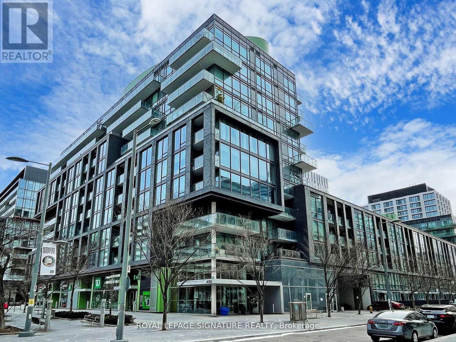 A modern multi-story building with glass windows and a sign that reads "Royal LePage Signature Realty Brokerage.".