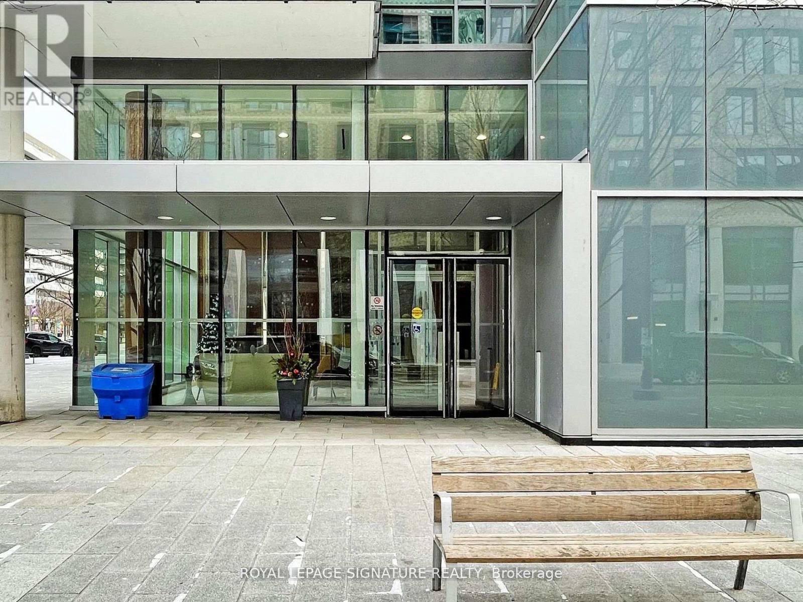 A building with glass doors and windows is labeled with "Royal Tepage Signature Realty Brokerage.".