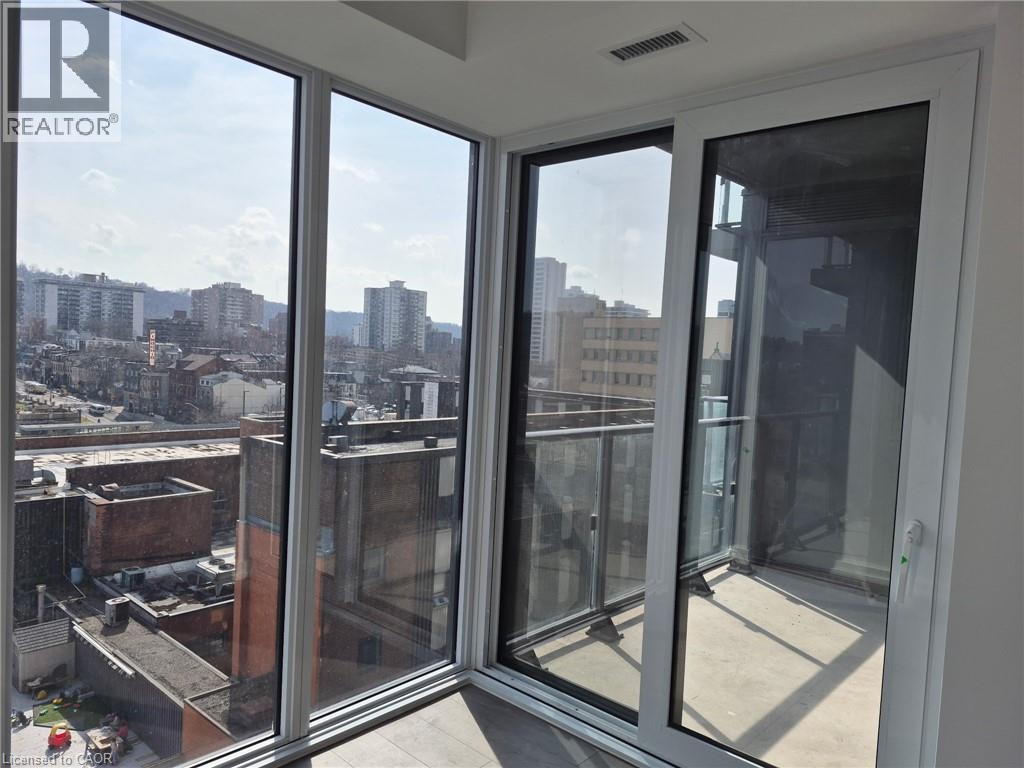 A view from a window looking out at a cityscape.