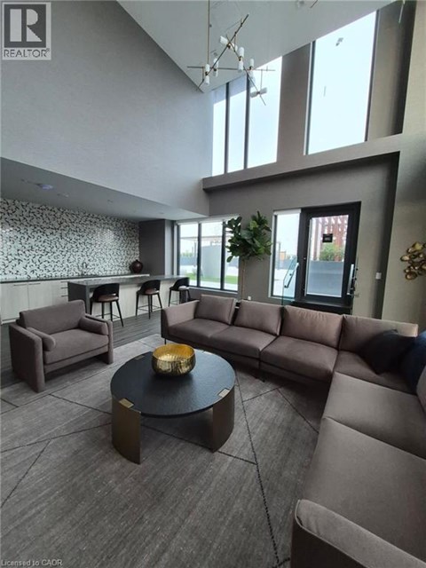 A living room with a grey couch and a black coffee table.