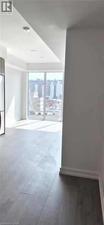 A spacious room with a large window overlooking a cityscape.