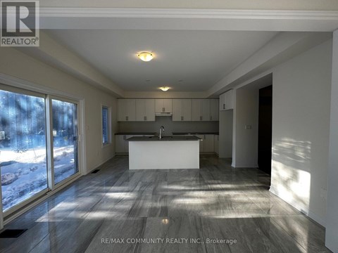 A spacious kitchen and living room with a large island in the middle.