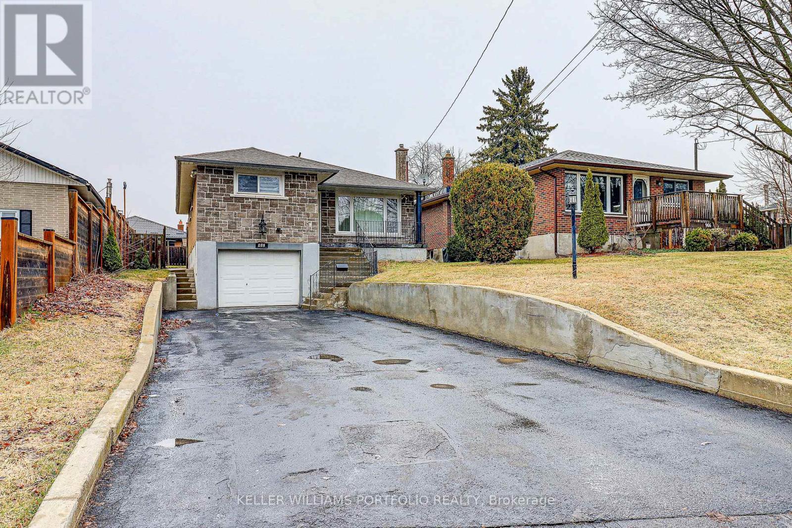 A house with a driveway in front of it.