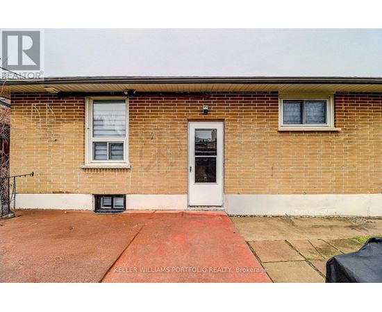 A brick house with a black door and windows.