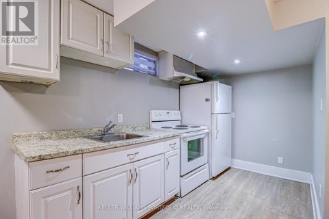 A kitchen with white cabinets and a granite countertop.