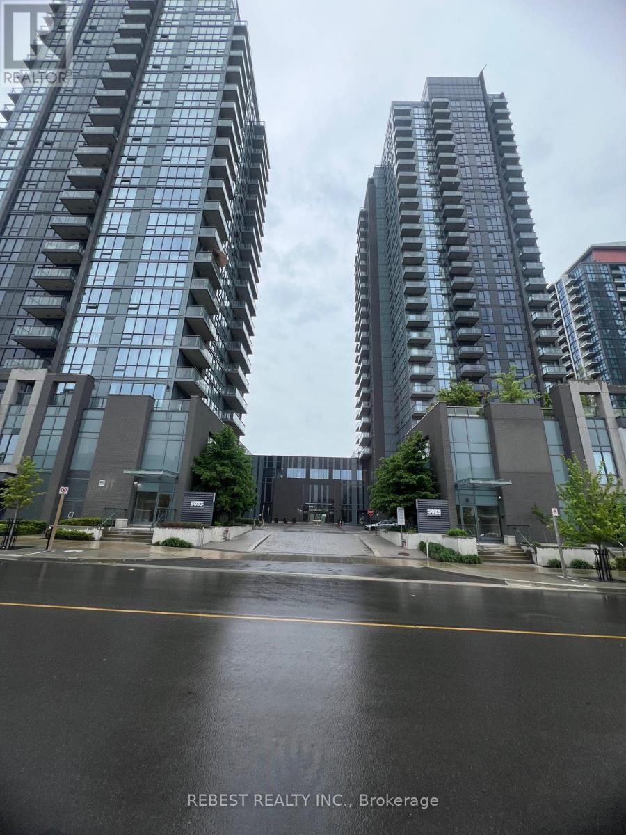 A tall building with the word READY on it stands in front of other buildings.
