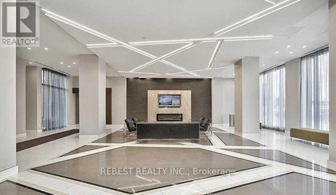 A spacious living room with a central television and a marble floor.