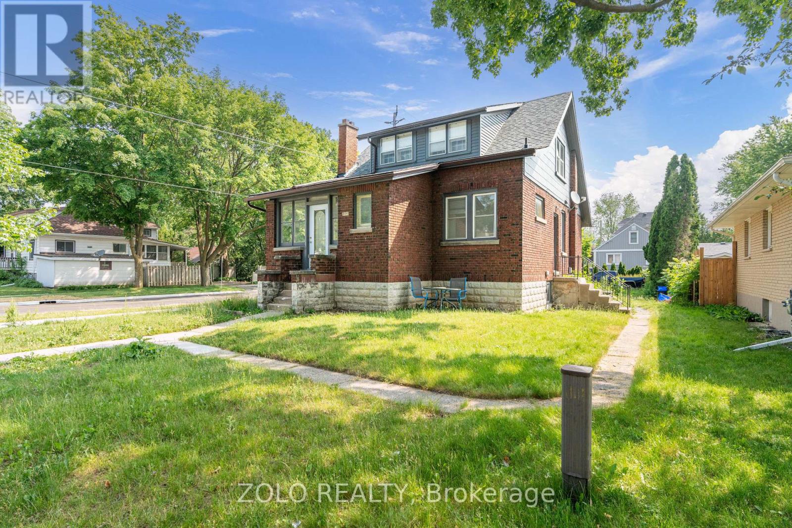 A house with a lawn in front of it is for sale.
