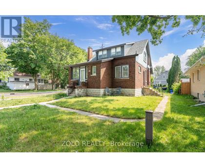 A house with a lawn in front of it is for sale.