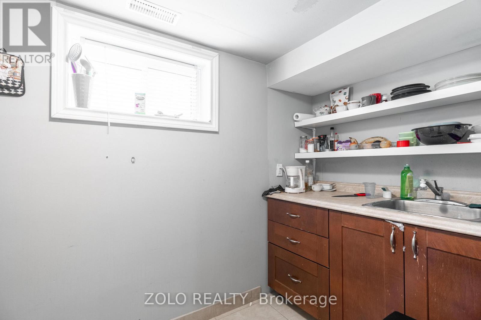 A kitchen with wooden cabinets and a white fridge.
