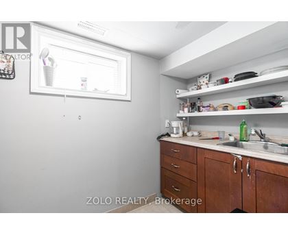 A kitchen with wooden cabinets and a white fridge.