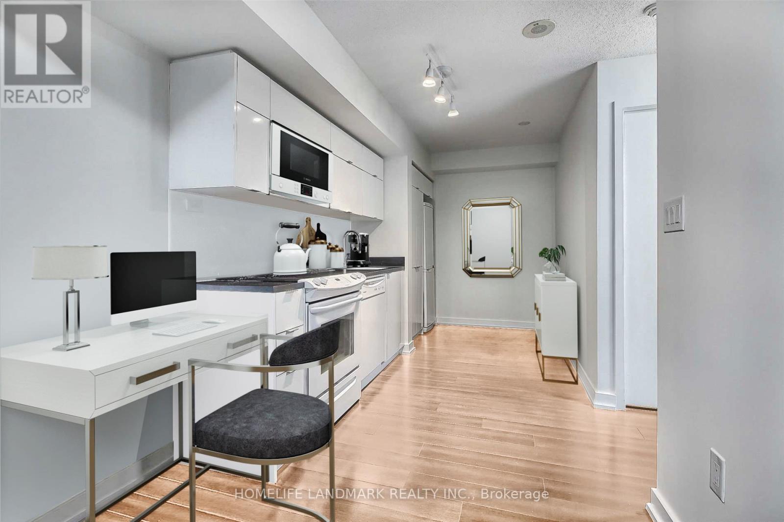 A kitchen with white cabinets and a black countertop.