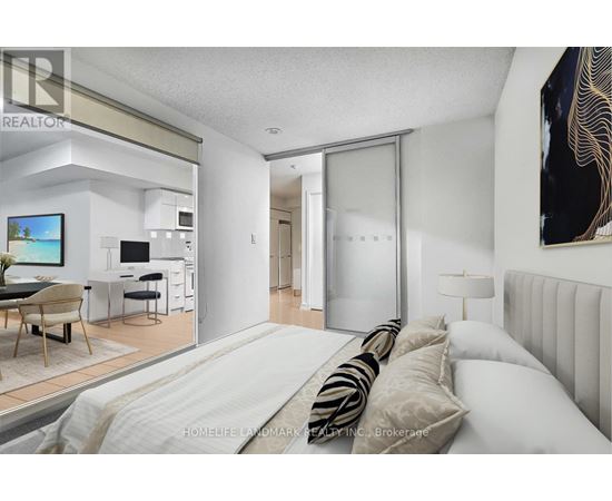 A bedroom with a large bed and a television in the living room.