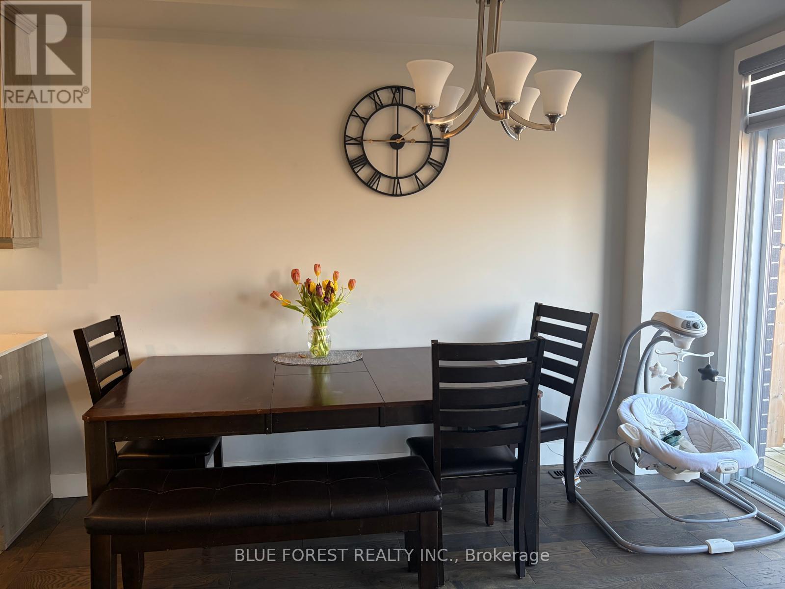 A dining room with a wooden table and chairs.