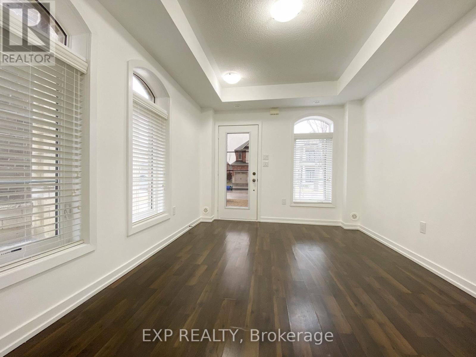 A room with wooden floors and white walls.