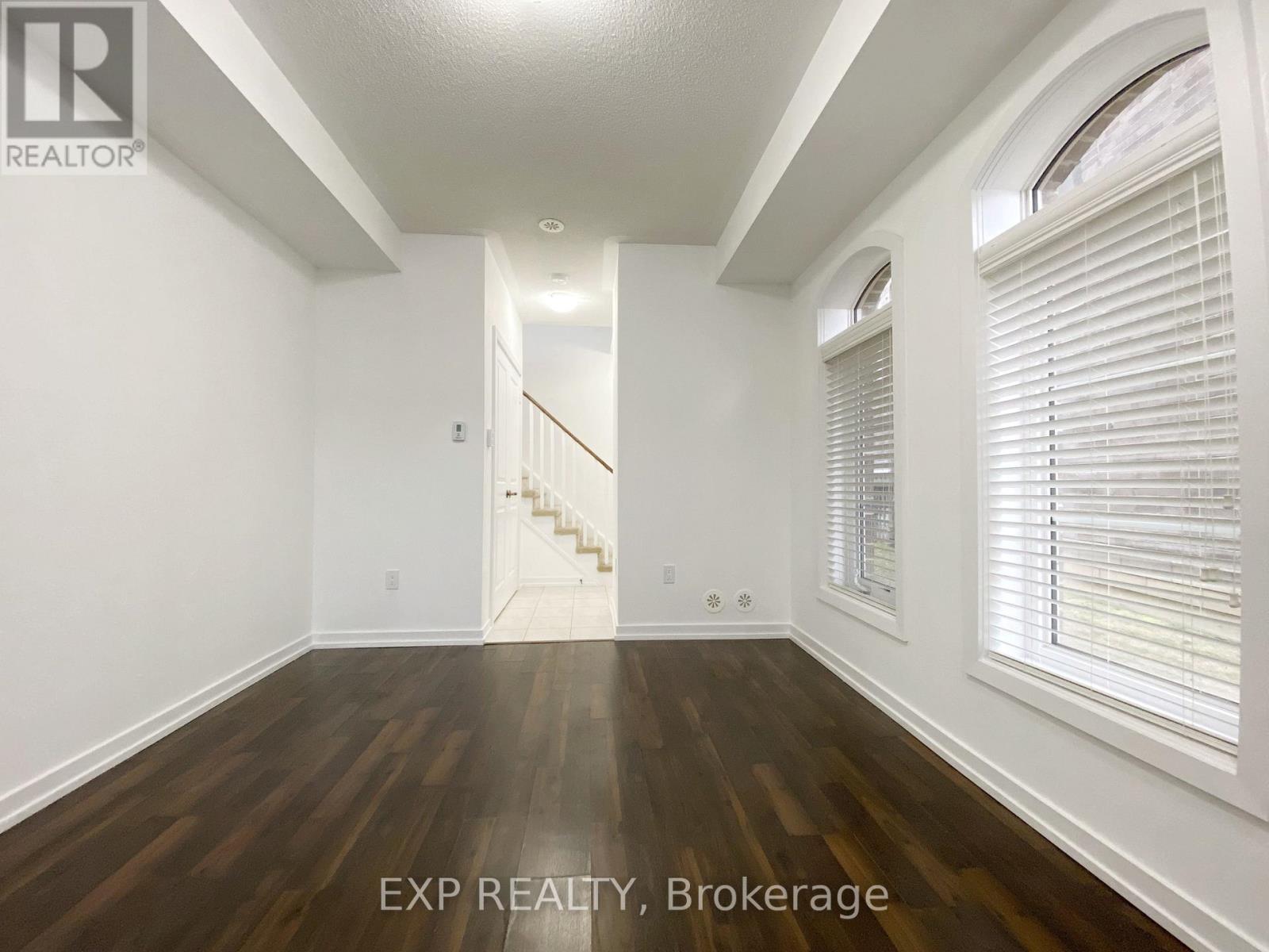 A room with wooden floors and white walls.