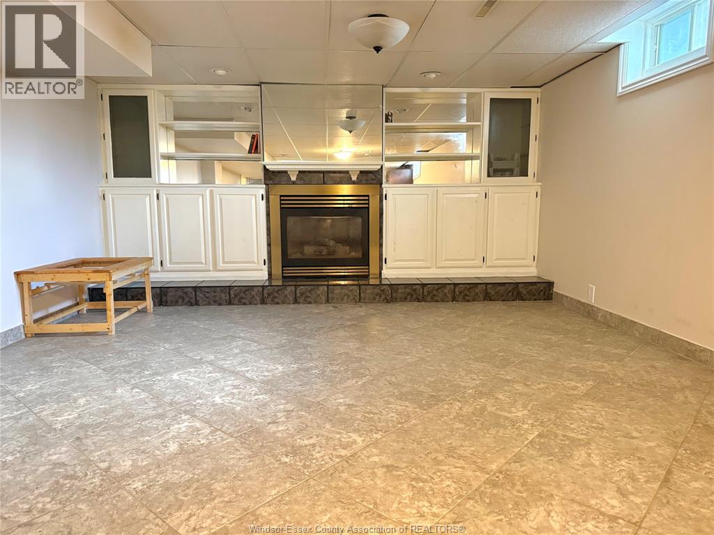 A living room with a fireplace and built-in cabinets.