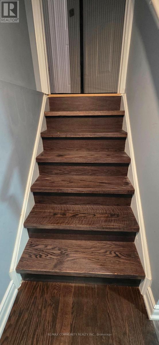 A set of wooden stairs with white trim.